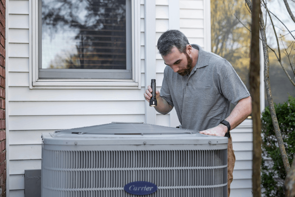 HVAC technician servicing air conditioning in New York